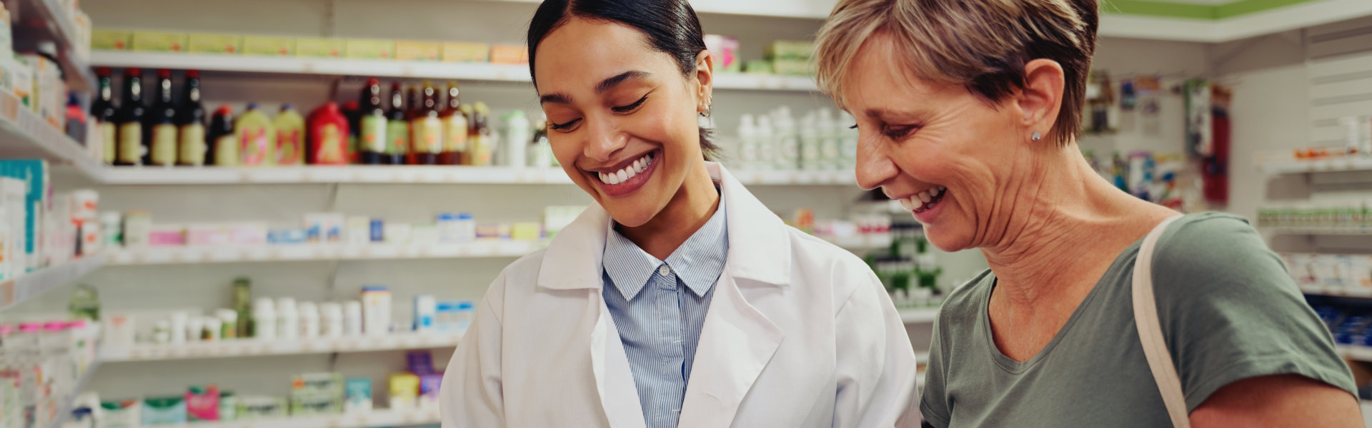 pharmacist and elderly smiling together